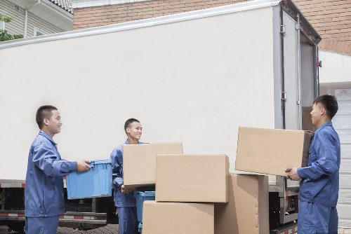 Careful loading of household items into a moving vehicle near Finsbury Park