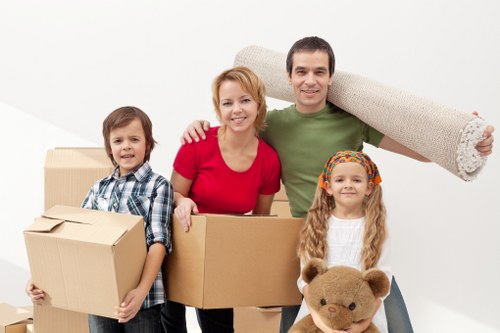 Packed moving boxes and furniture ready for transport in a North London home